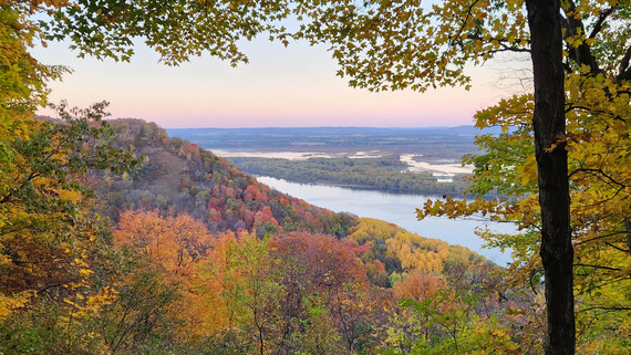 A stunning overlook of bluffs and river valley at sunrise in the fall. 