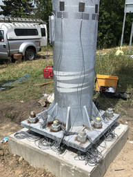 Baseplate on a lightpole showing bolts and nuts