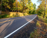 Rural paved road with white side striping and double yellow center line