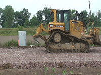 A grader used to level a base course.