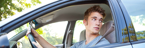 Teen male driver in car