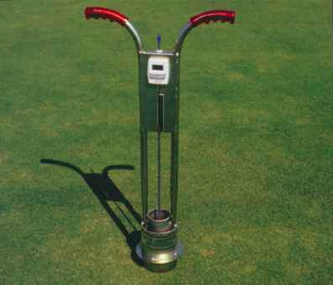 A waist-high metal tool with red handles and two vertical rods attached to a can-like double-ring apparatus that is inserted into the ground
