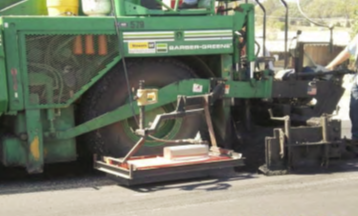 Construction equipment compacting asphalt.