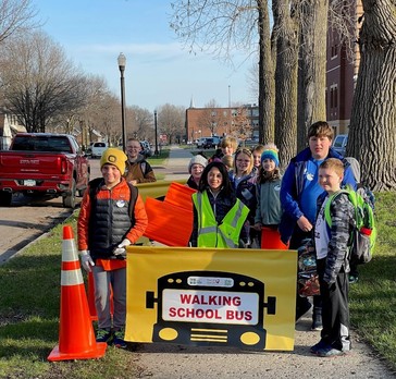 Students holding a Walking School Bus sign