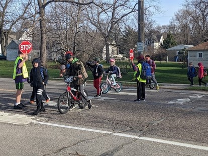 Bikes and pedestrians crossing in a crosswalk