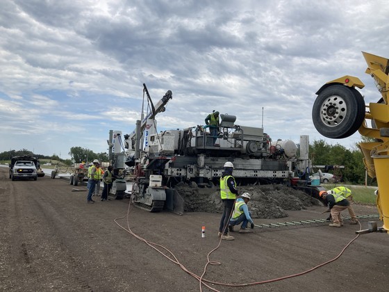 Photo of construction crews pouring concrete acceleration lanes for southbound Highway 52 at Highway 60 east.