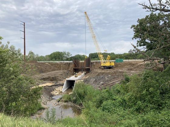 Photo of construction crews installing a box culvert on southbound Highway 52 at Hader.
