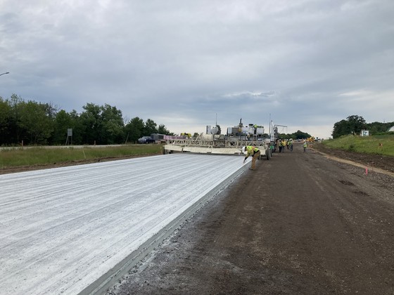 Photo of construction crews marking new concrete on Highway 52 southbound lane at Highway 60 east.