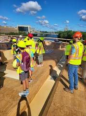 National Summer Transportation Institute students tour a bridge with Ames Construction