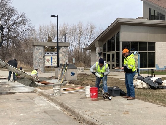 At the Cass Lake Rest Area, MnDOT training participants improve sidewalks to meet standards set by the Americans with Disabilities Act. 