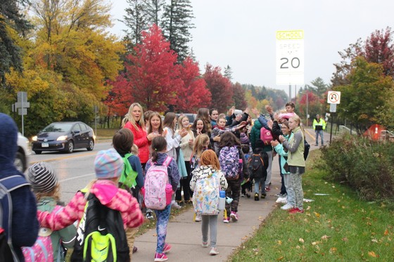 Congdon Park Elementary School students line up at bus stop in Duluth