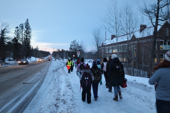 Group of kids walking in the winter in the snow to school.