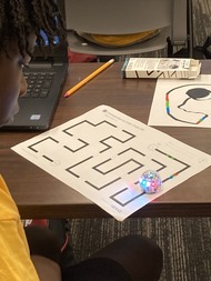 National Summer Transportation Institute participant observes a bot following a color-coded track