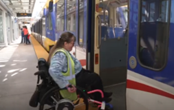 Woman in wheelchair boarding light rail