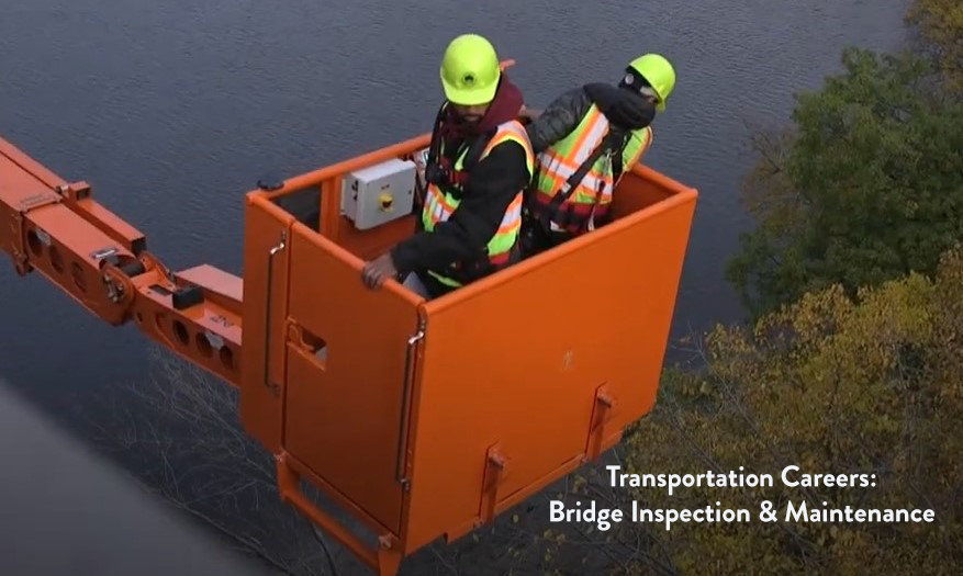 Workers inspecting bridges from snooper truck