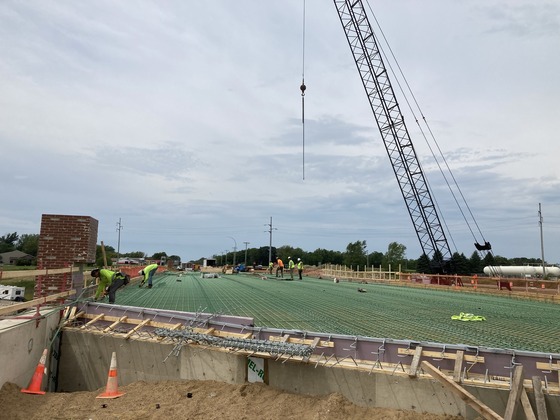 Photo showing construction workers preparing the Highway 105 bridge over Interstate 90 for a concrete pour for the bridge deck in Austin, Minnesota.