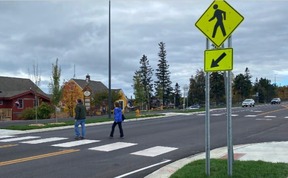 People crossing street at marked crosswalk