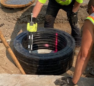 Adjusting rings being installed over exposed utility structure