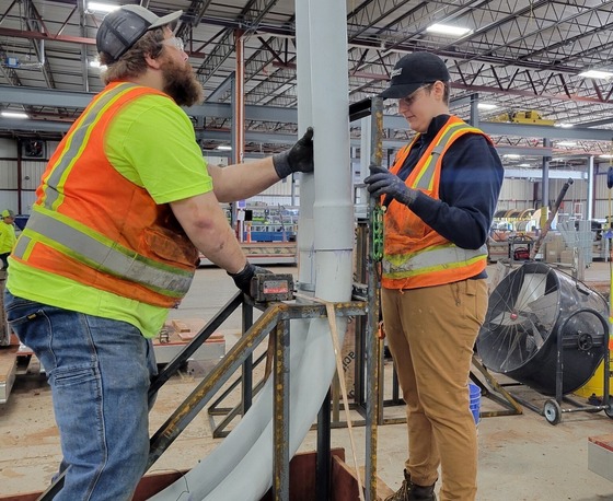 Cora Holt (on the right) on the job as a first-year apprentice electrician