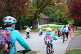 kids biking on street and sidewalk