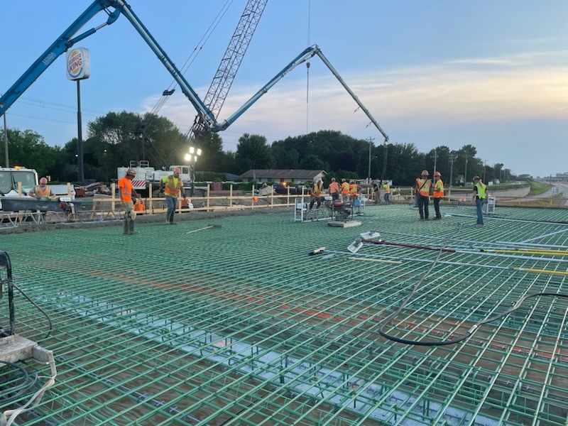Photo of construction crews pouring concrete to build bridge deck at Fourth Street Northwest over Interstate 90 in Austin, Minnesota.