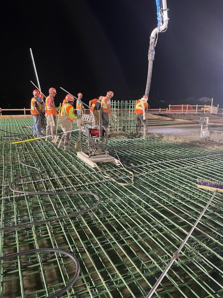 Construction workers work with concrete on Fourth Street Northwest bridge over Interstate 90 in Austin, Minnesota.