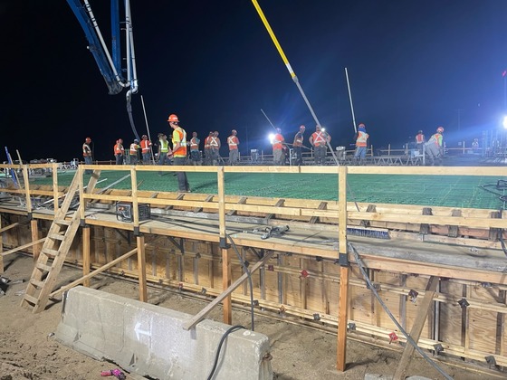 Construction crews at work during concrete deck pour of Fourth Street Northwest bridge over Interstate 90 in Austin, Minnesota.