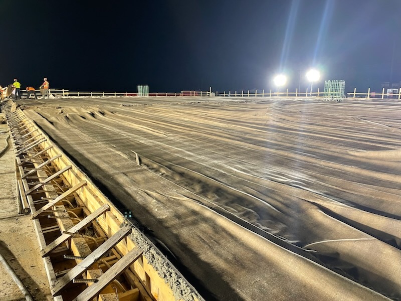 Protective cover is placed over new concrete on bridge deck at Fourth Street Northwest over Interstate 90 in Austin, Minnesota.