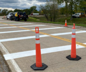 Pavement markings being applied on road