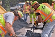 Maintenance workers repairing pavement