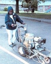 Miller operating a striping machine in her commercial painting days