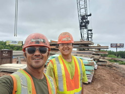 Sher Vang, pile driver apprentice with his cousin on a job site in Hinckley, MN. 