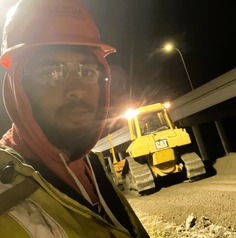 Jonathon Judge, laborer apprentice, working a night shift on a haul road. 