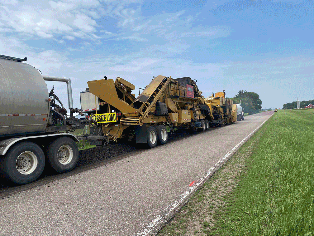 A gif file animates different scenes from asphalt laydown on a road