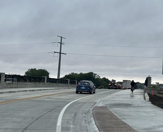 Cyclist uses the trail to cross the bridge 
