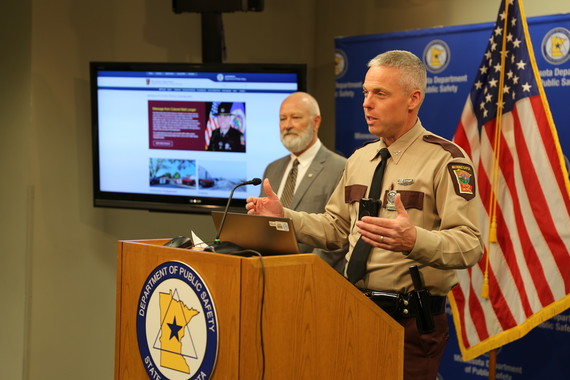 Col. Matt Langer presents the new dashboard at the podium while Commissioner Jacobson looks on.