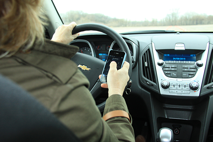 Woman driving and texting