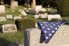 American flag folded on a headstone