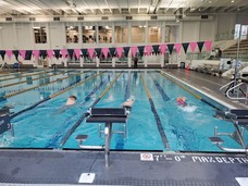 Event participants swimming in the Community Center pool