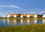 Seven traditional tipis in front of Hoċokata Ti cultural center
