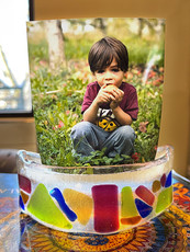 Glass photo holder displaying a photo of a kid