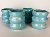 4 turquoise colored ceramic vases