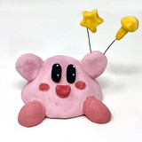 Clay pig holding balloons