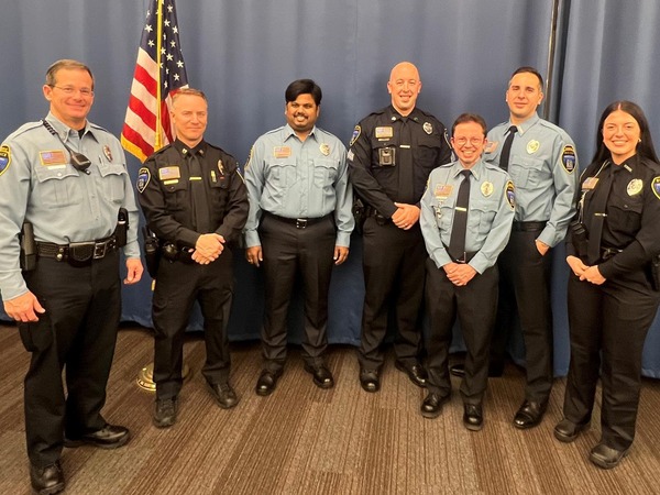Three new reserve officers smile with three EPPD officers