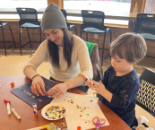 Adult and child working on a craft project together