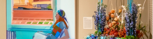 Painting next to flower bouquet that matches painting