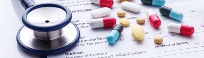 Stethoscope and scattered pills