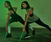 Two women participating in a POUND fitness session