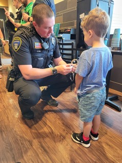 An EPPD officer talks with a little boy