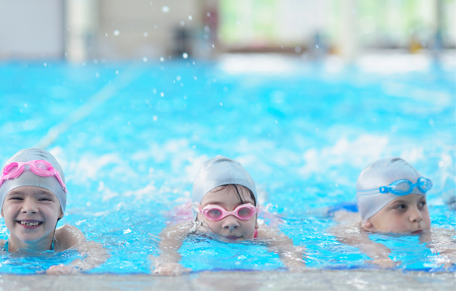 Three kids during a swimming lesson